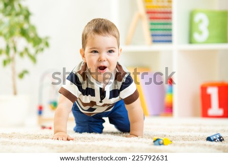 child boy playing with toys indoor on floor