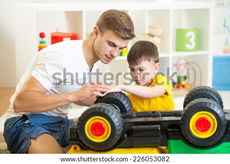 child boy and father repair toy car