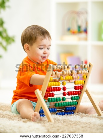 smiling kid boy playing with counter toy