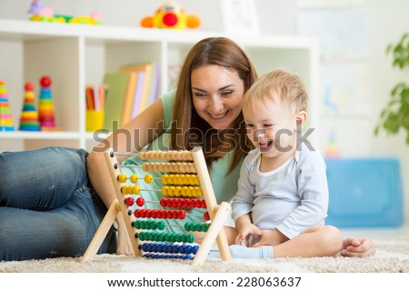 kid and his mother playing with abacus