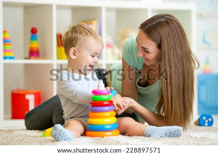 cute mother and child boy playing together indoor at home
