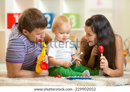 Happy family play musical toys at home