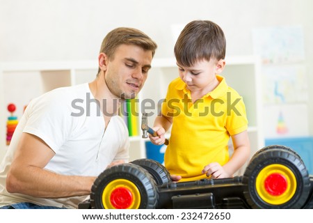 kid boy and daddy repair toy car
