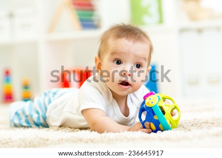 little boy playing with toy indoor at nursery