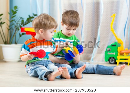 two kids boys play together with educational toys