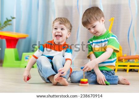 children boys with educational toy in playroom