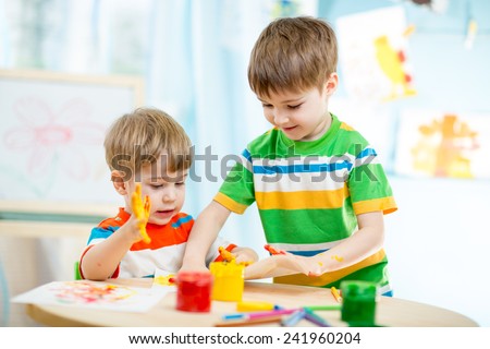 kids playing and painting at homeor kindergarten or playschool or daycare
