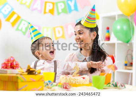 child boy and his mom have fun on birthday