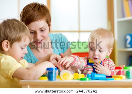 kids and woman play colorful clay toy indoor