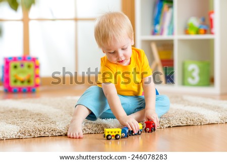 kid boy playing toys at home or kindergarten kid boy playing toys at home or kindergarten