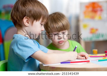 children boys painting in nursery at home