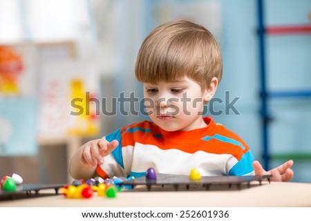 kid playing with educational toys on a table