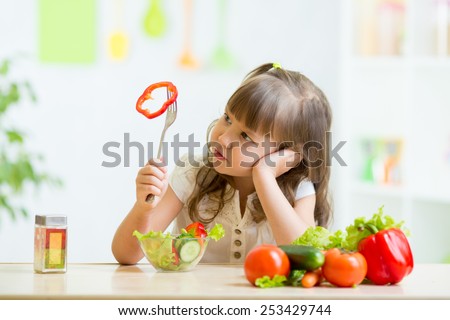 pretty kid girl refusing to eat her dinner healthy vegetables