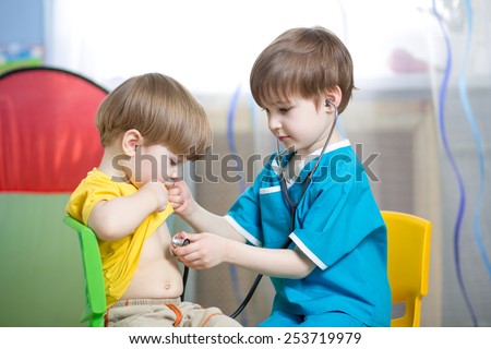 children boys play doctor together at home