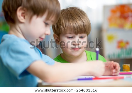 children brothers painting in nursery at home