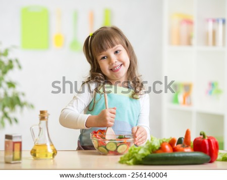 kid girl preparing healthy food at kitchen