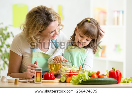 mom and kid girl preparing healthy food at home