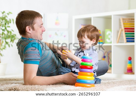 happy father and child son playing together indoor at home