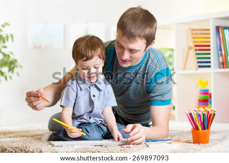 child boy painting in nursery at home