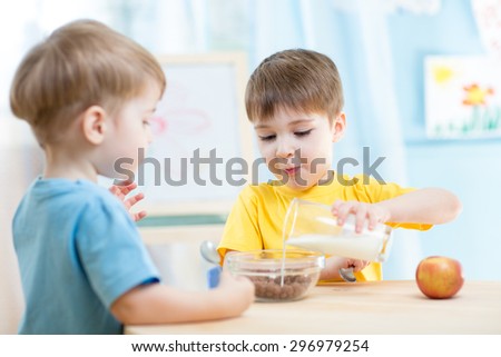 little children eating healthy food at home