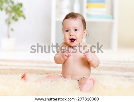 cute baby sitting on fluffy carpet at home