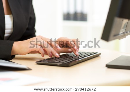 Office worker typing on keyboard in office