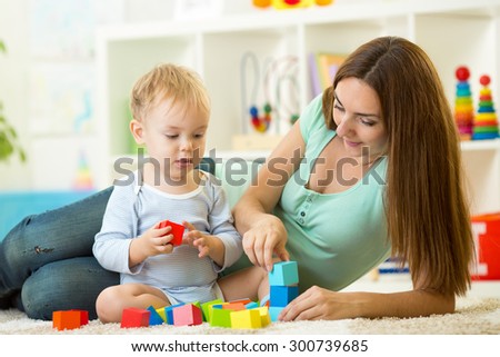 mom with her child son play together at home