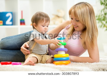 child boy playing together in nursery at home