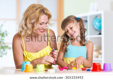 Children playing with colorful clay molding different shapes