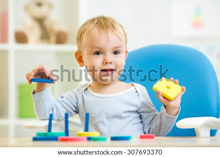 kid plays with education toys in daycare center