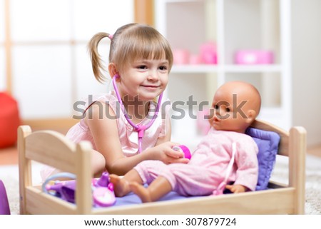 Cute Child Playing Doctor with doll Toy