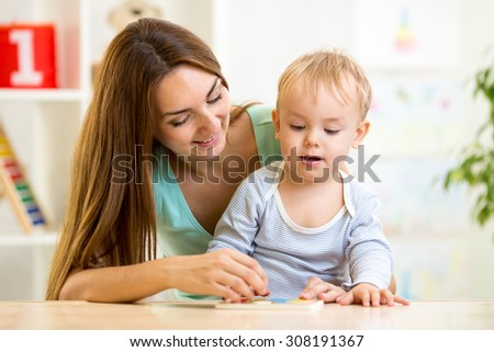 mother teaching her son child solve puzzle