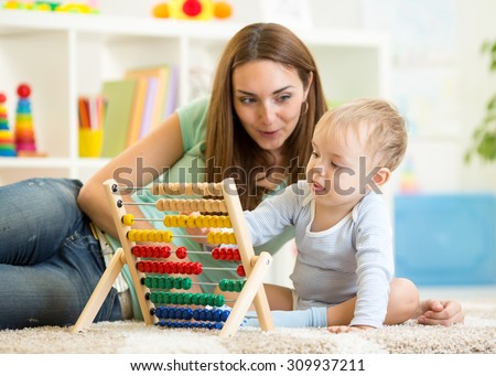 kid and mother play with abacus at home