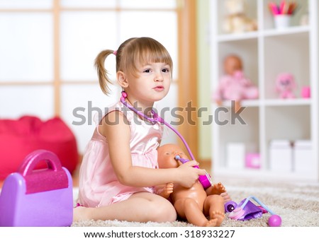 Little girl playing with baby dolls in hospital