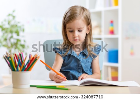 child kid girl paints in her nursery at home