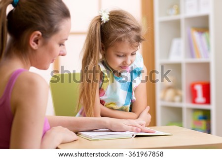 Elementary Pupil Reading With Teacher