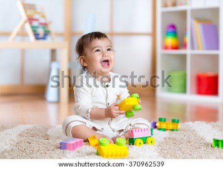 kid playing with building blocks at kindergarten