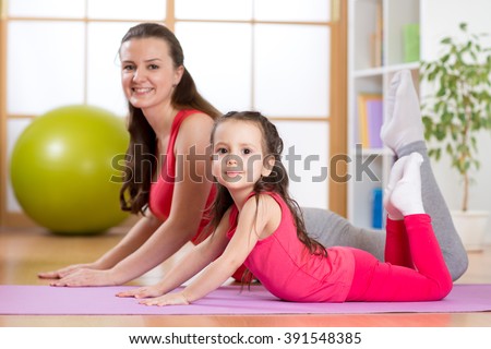 Mom and kid do gymnastics. Family sports