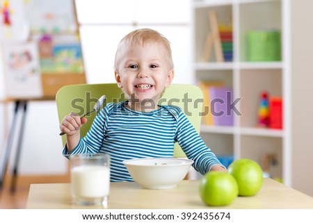 kid eating healthy food at home or kindergarten