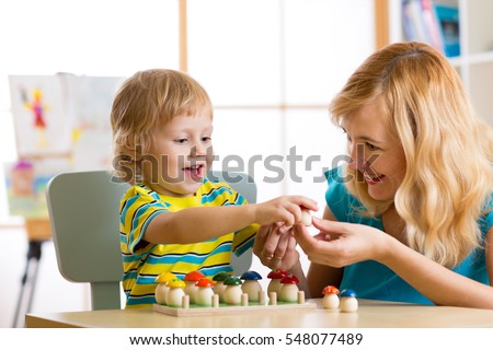 Mother and child learn color, size, count while playing together. Early education concept.