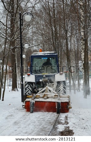 Tractor which cleaning a road in the park