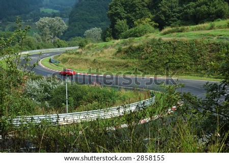 mountain road with a car in the forest