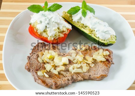 Beef steak with fried onion and stuffed vegetables