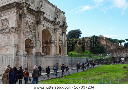 ROME-DEC 1: Tourists around the Arch of Constantin on Dec 1, 2012 in Rome. The Arch of Constantin, next to the Colosseum, is one of the best preserved monuments of the Rome