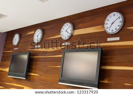Business Interiors wooded wall with flat TV or LCD screen and Worldwide Clocks-Time