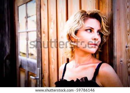 Concept for a CD-Cover - Woman posing in front of an old wooded home .. outdoor Portrait-Fotoshooting