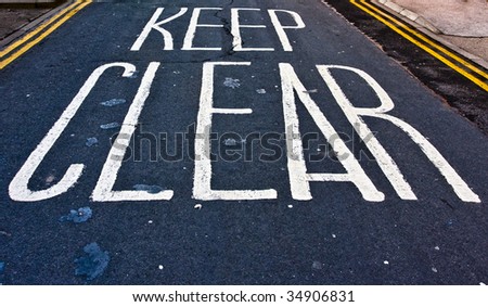 Keep clear written in white paint on a road surface