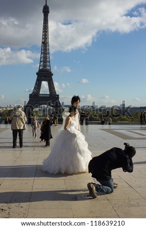 PARIS, FRANCE - NOVEMBER 06: shooting wedding of young couple in Paris on November 6, 2012 in Paris, France. Classic view of Eiffel tower is popular for marriages from all over the world.