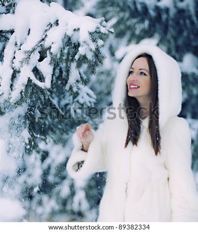 The beautiful woman in winter wood