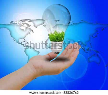 Light bulb in hand on world background